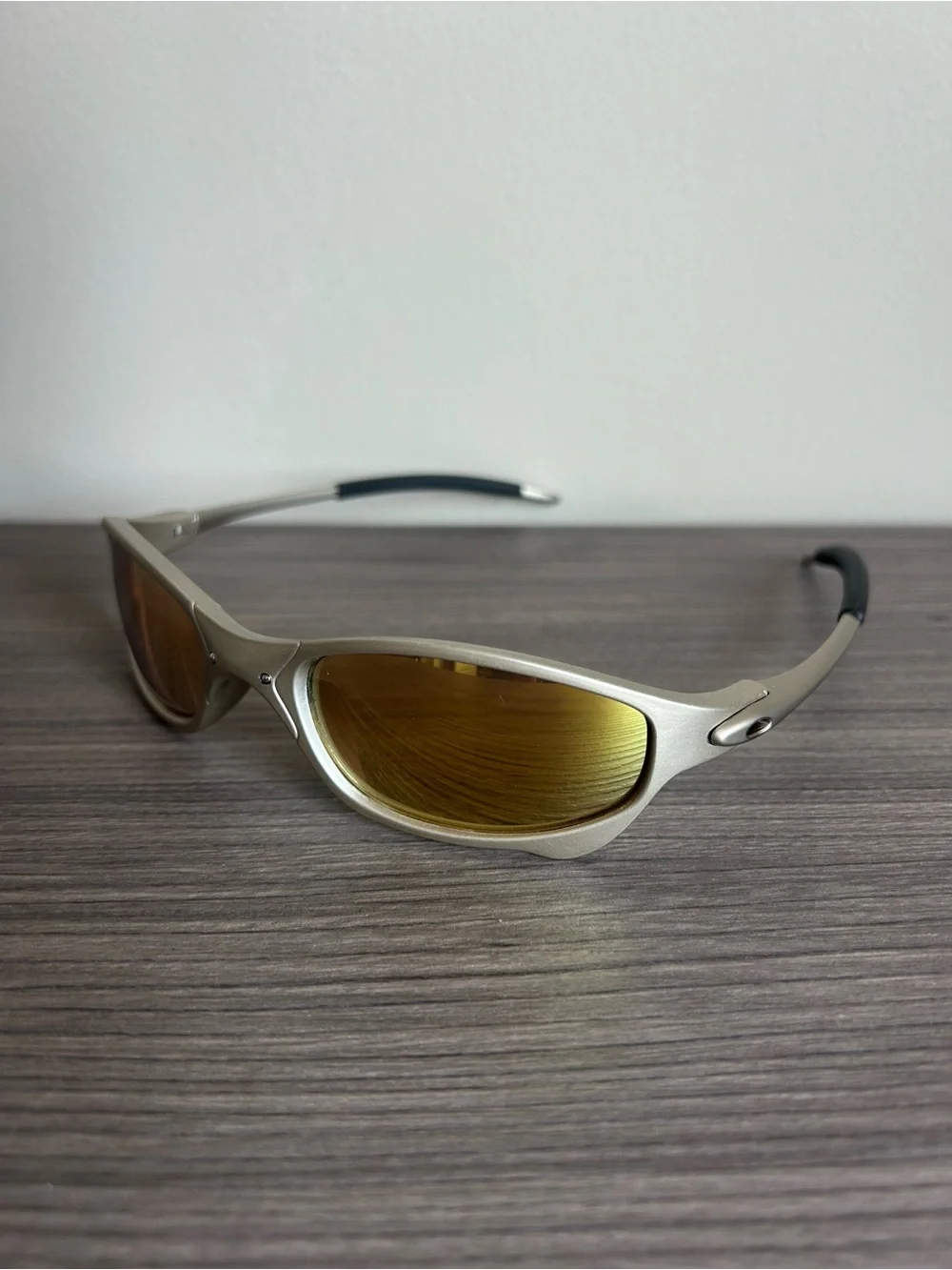 Oakley Silver Frame Sunglasses with Gold Mirrored Lenses